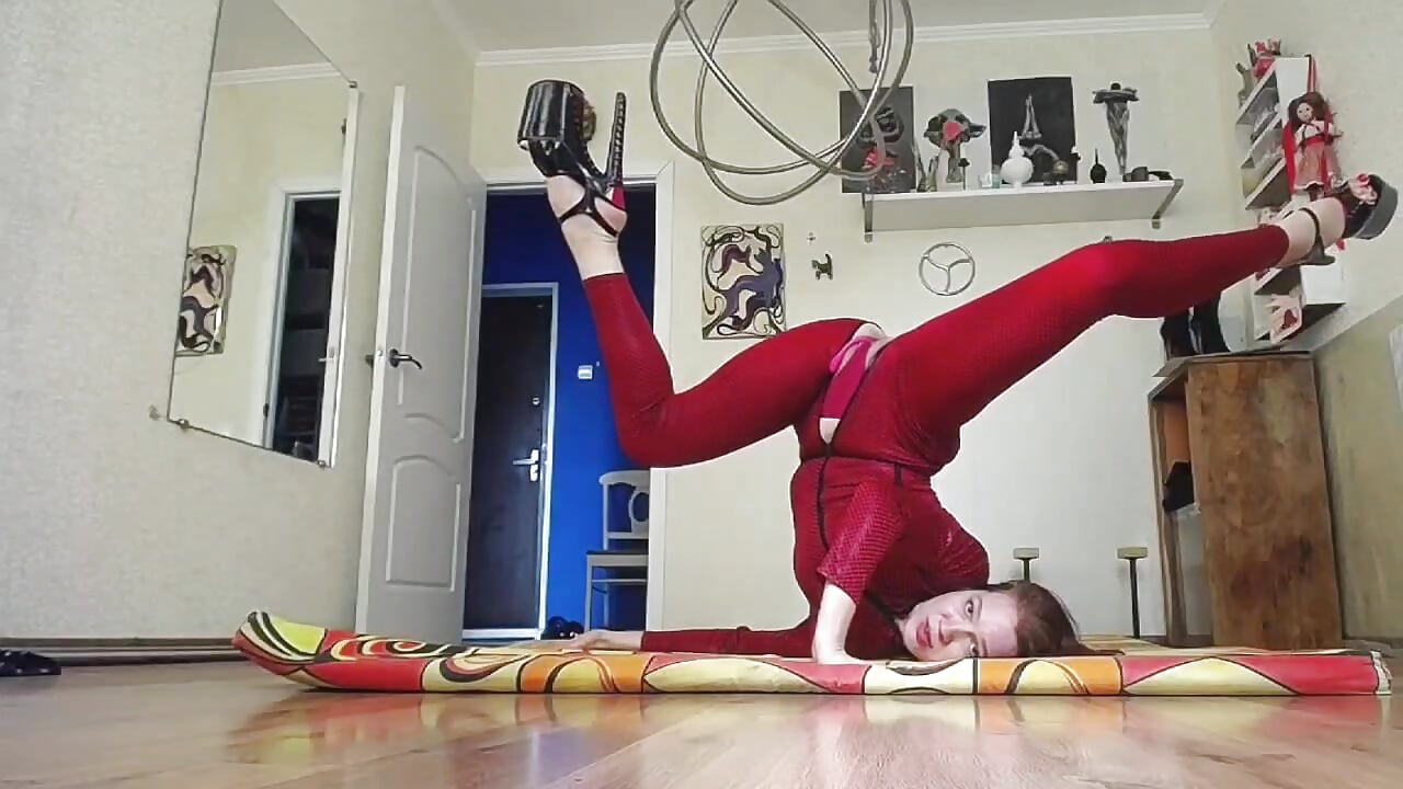 Gymnastics in  red catsuit and heels