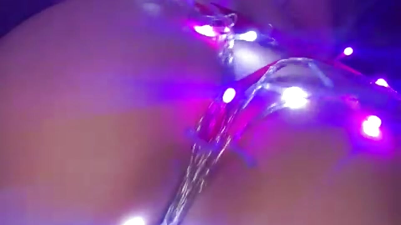 A hot girl wrapped in christmas lights