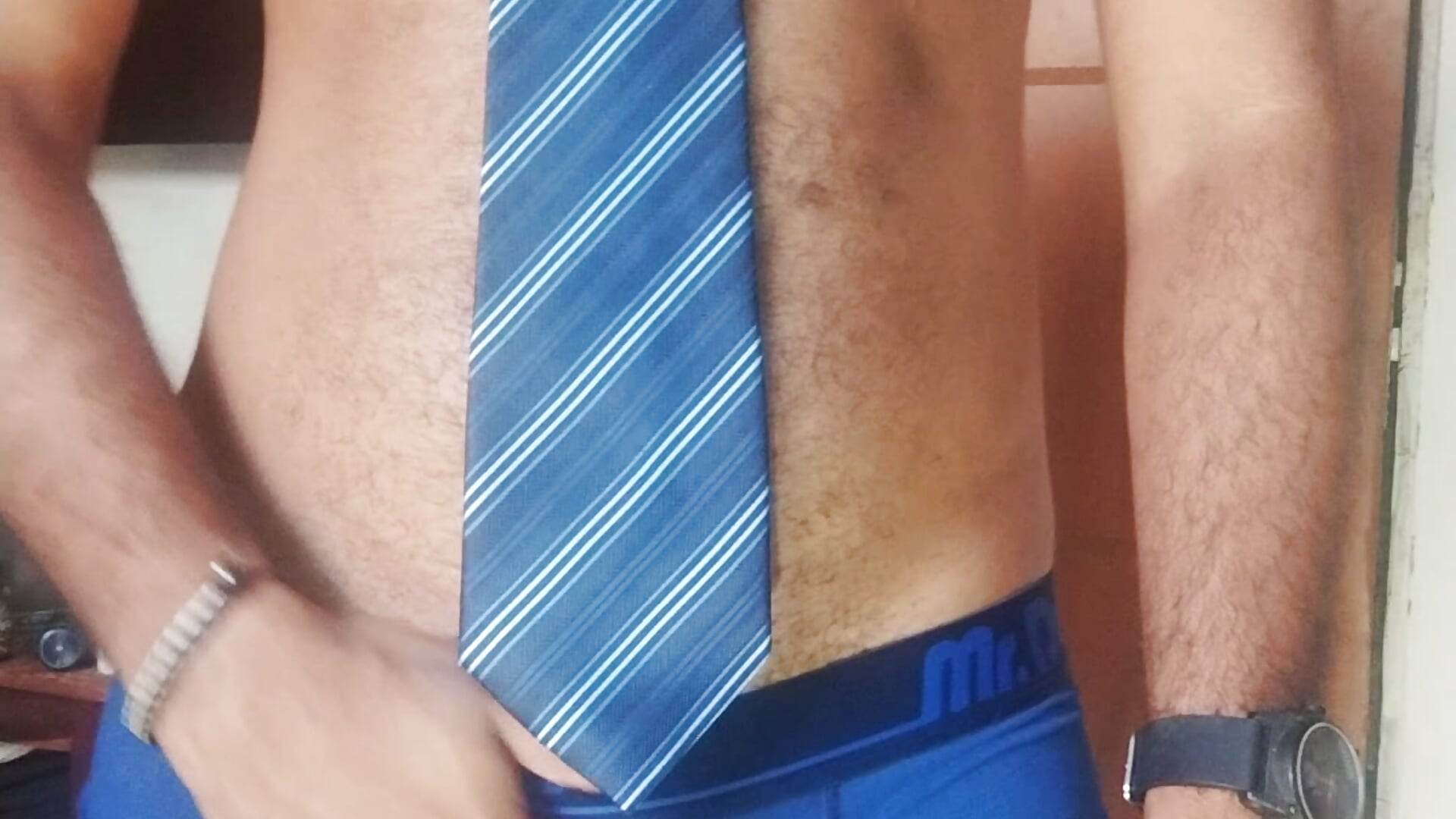 underwear strip with blue tie, hairy hard cock