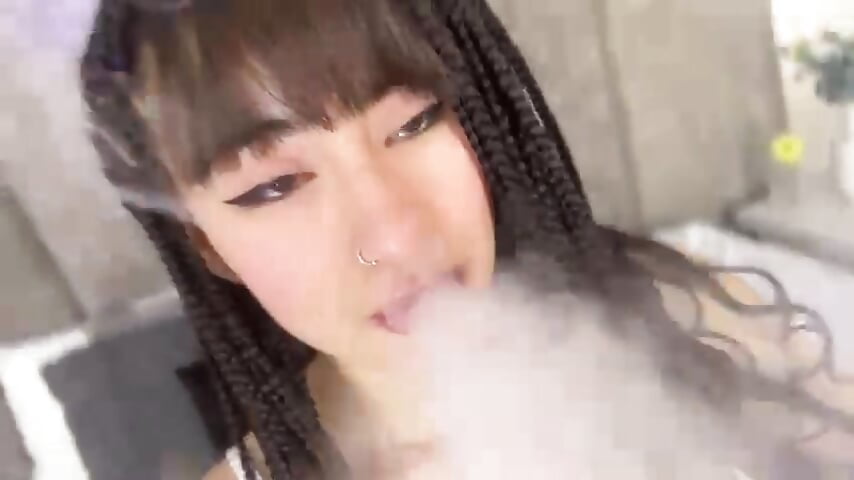 Sexy woman with smoke coming out of her mouth as her gaze consumes you.
