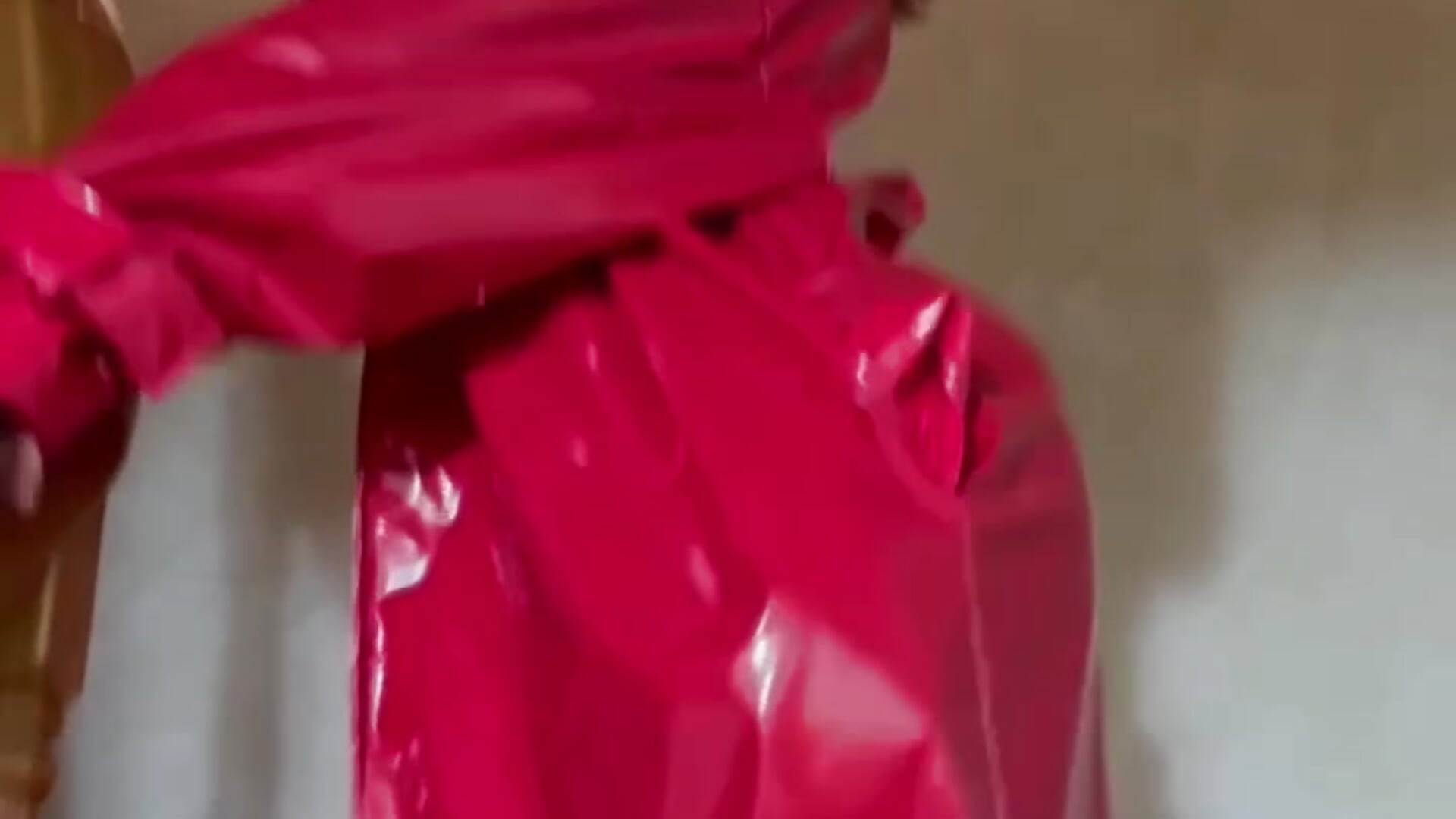naked in a red latex raincoat