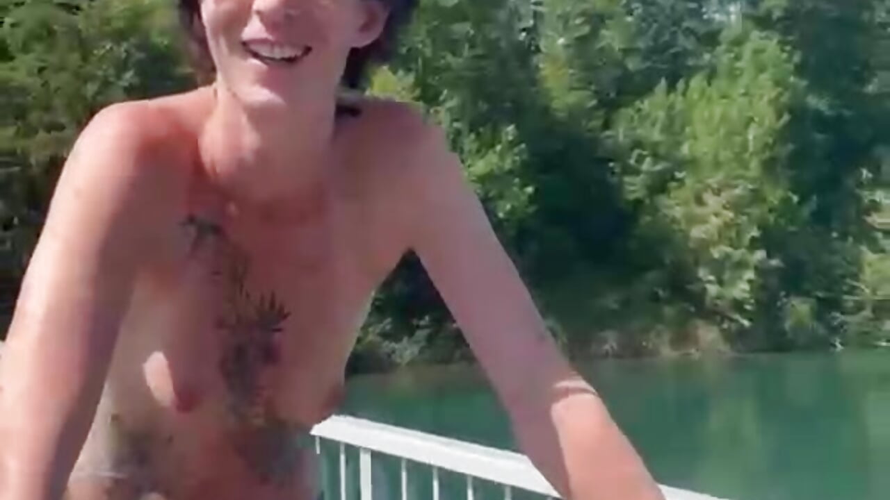 Topless on a Bicycle across the Bridge