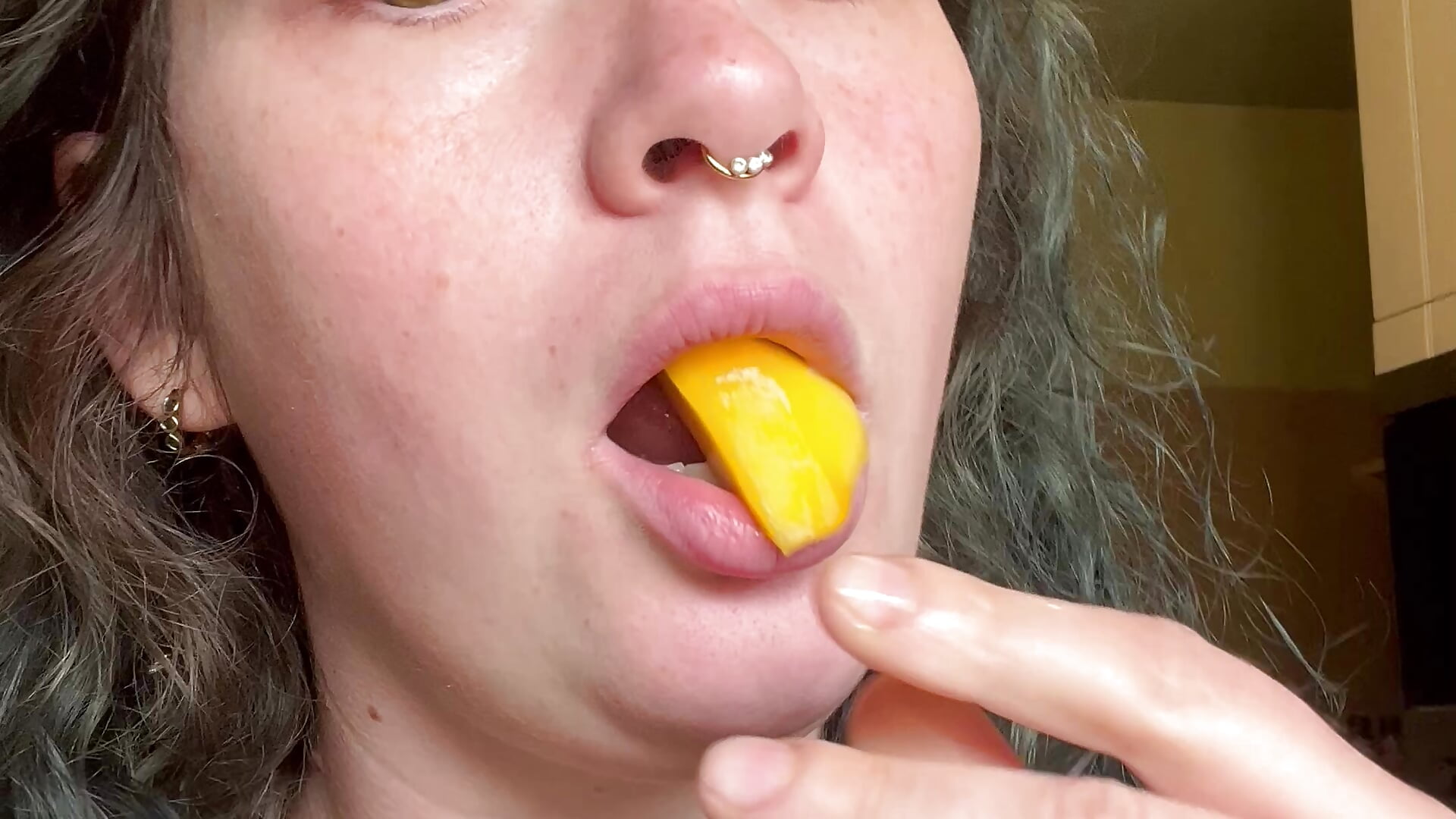 Cutie sucking on mango slices full deep