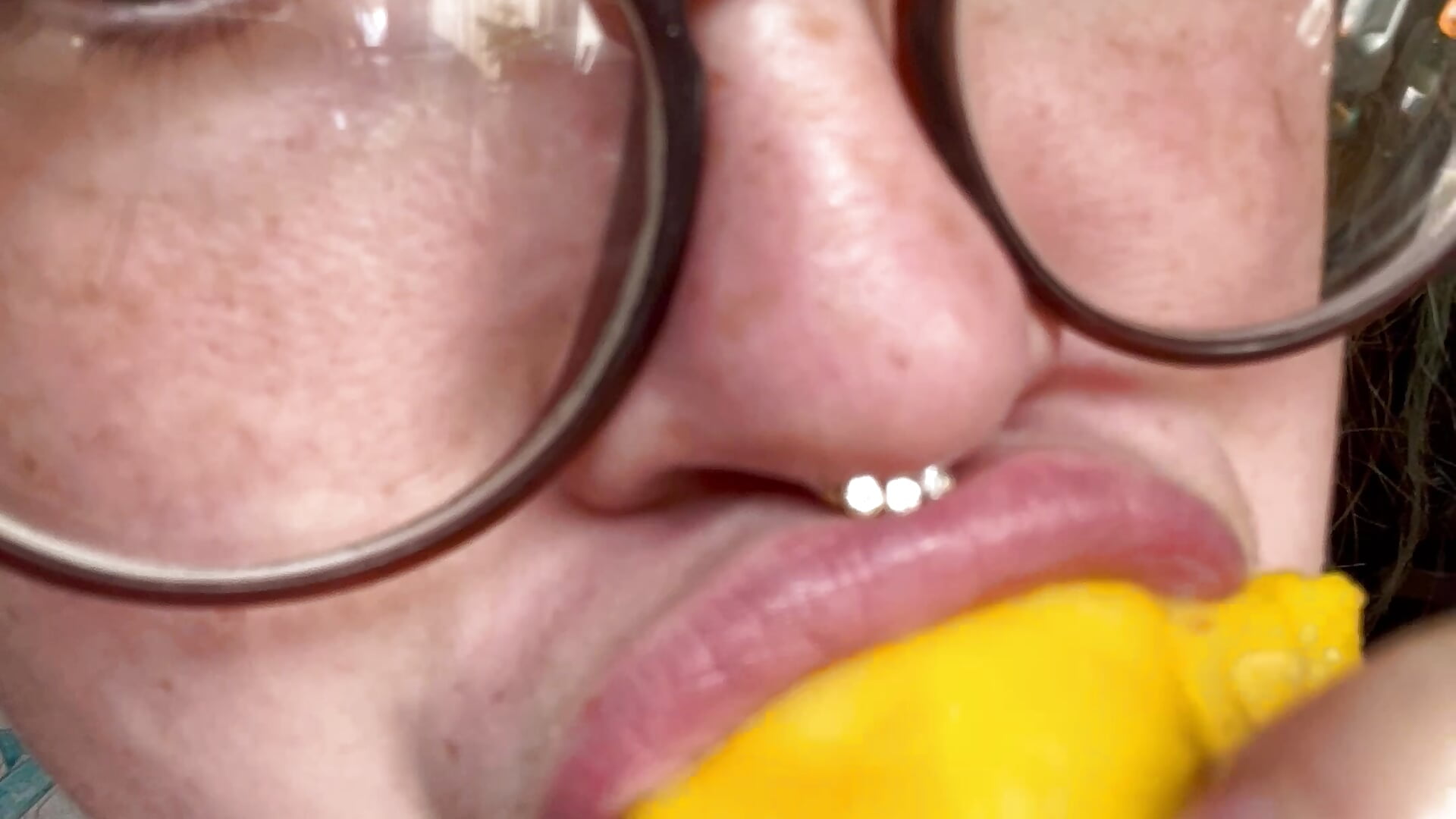 Morning cutie glasses eating and sucking on a mango