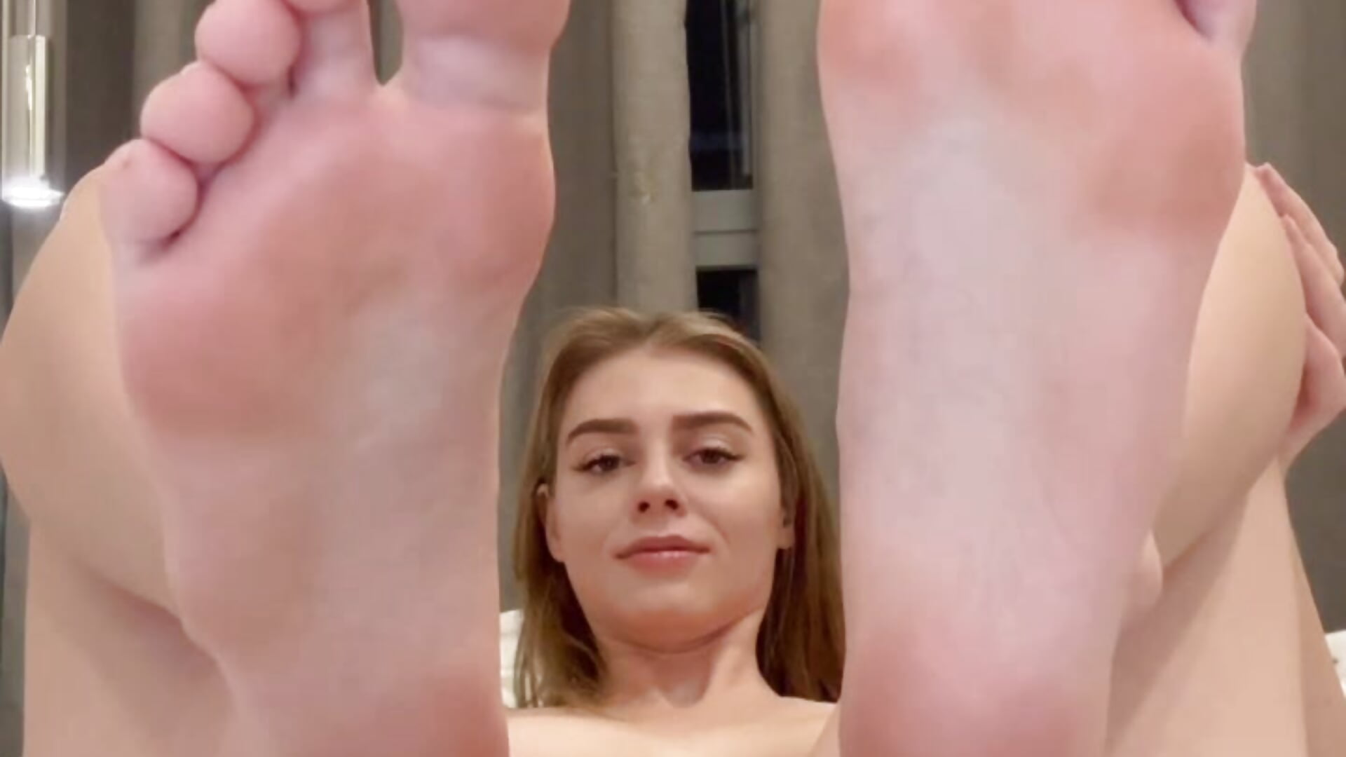 I'm undressed, showing you my feet and masturbating