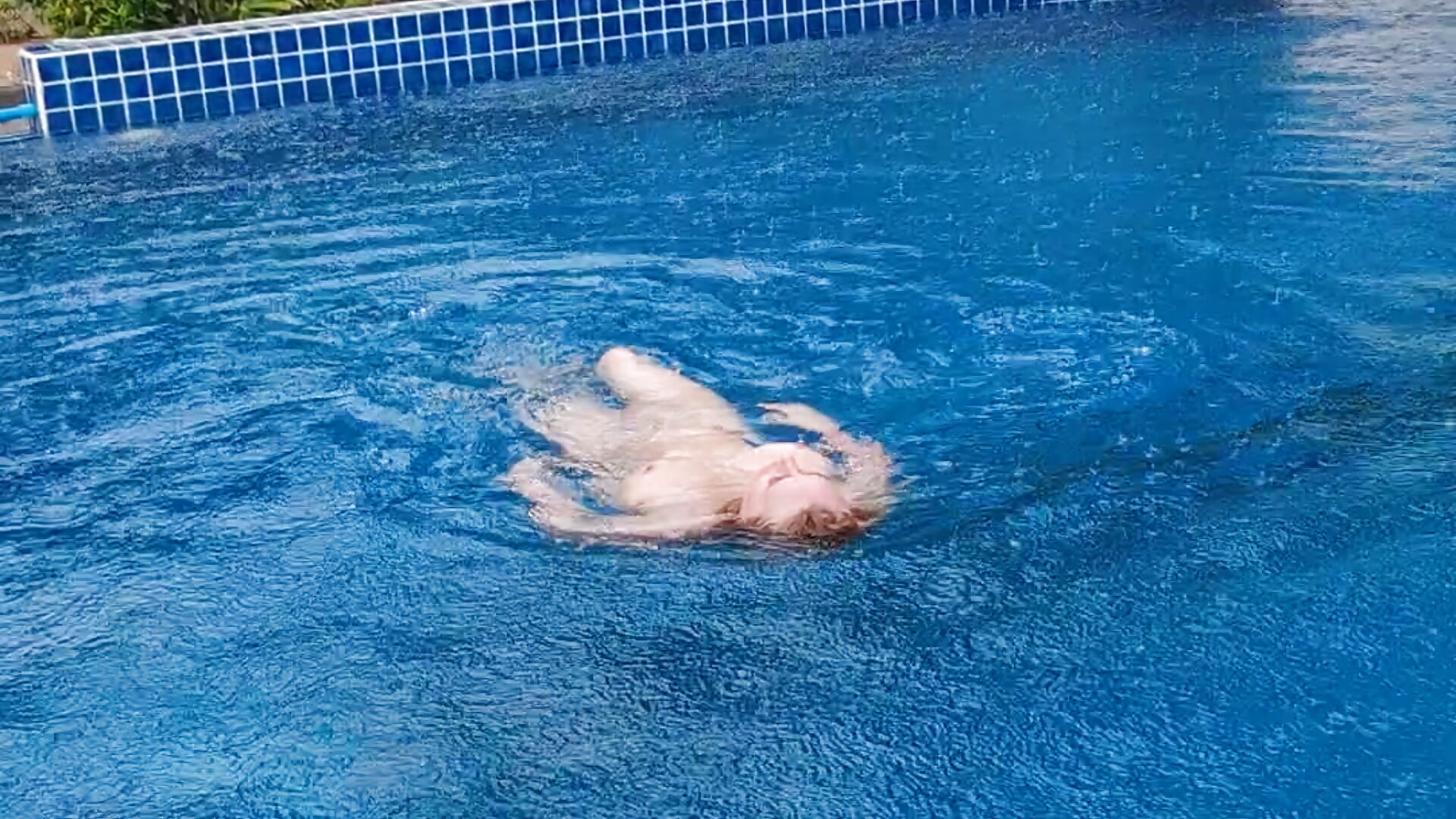 Swimming naked in the rain in the hotel pool.