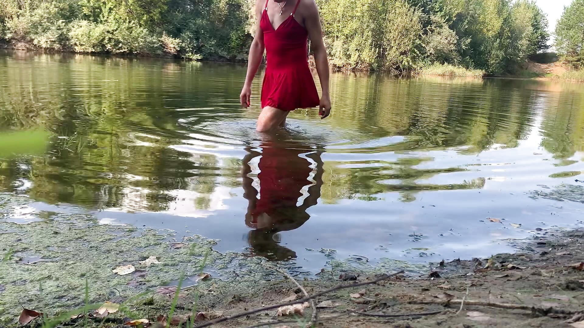 swimming in the lake in red dress