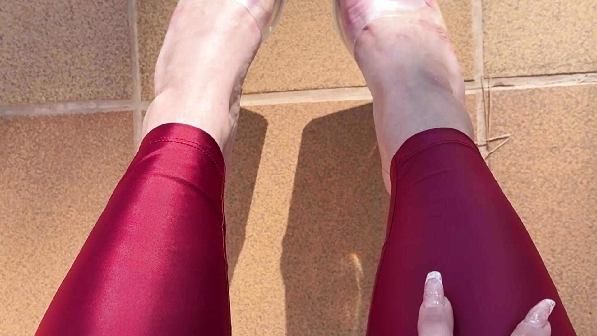 Legs in shiny red leggings and my sexy feet in transparent heels